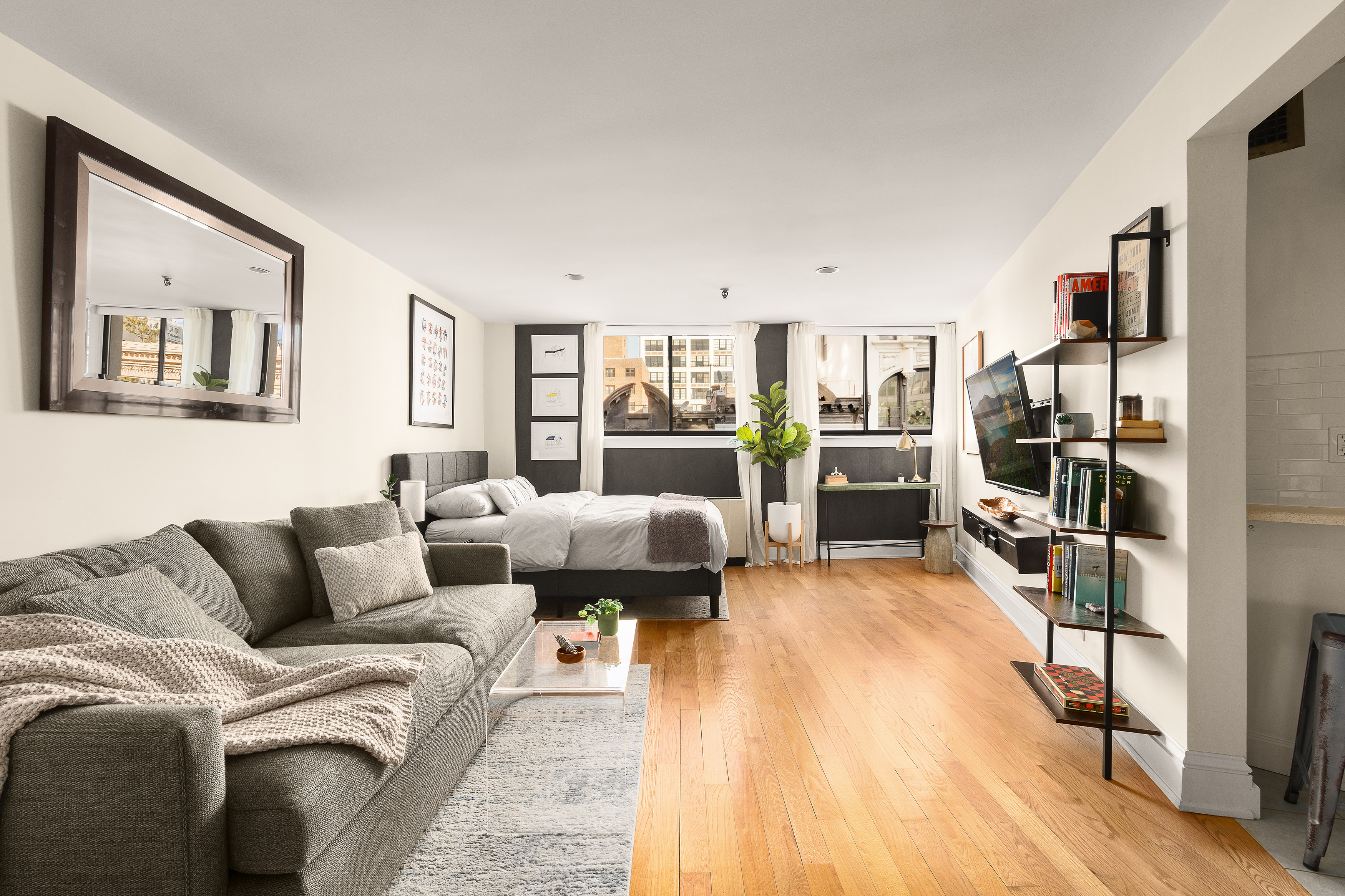 67 East 11th Street, Unit 624 Manhattan, NY 10003 - Photo 2 of 13 a living room with furniture and a flat screen tv