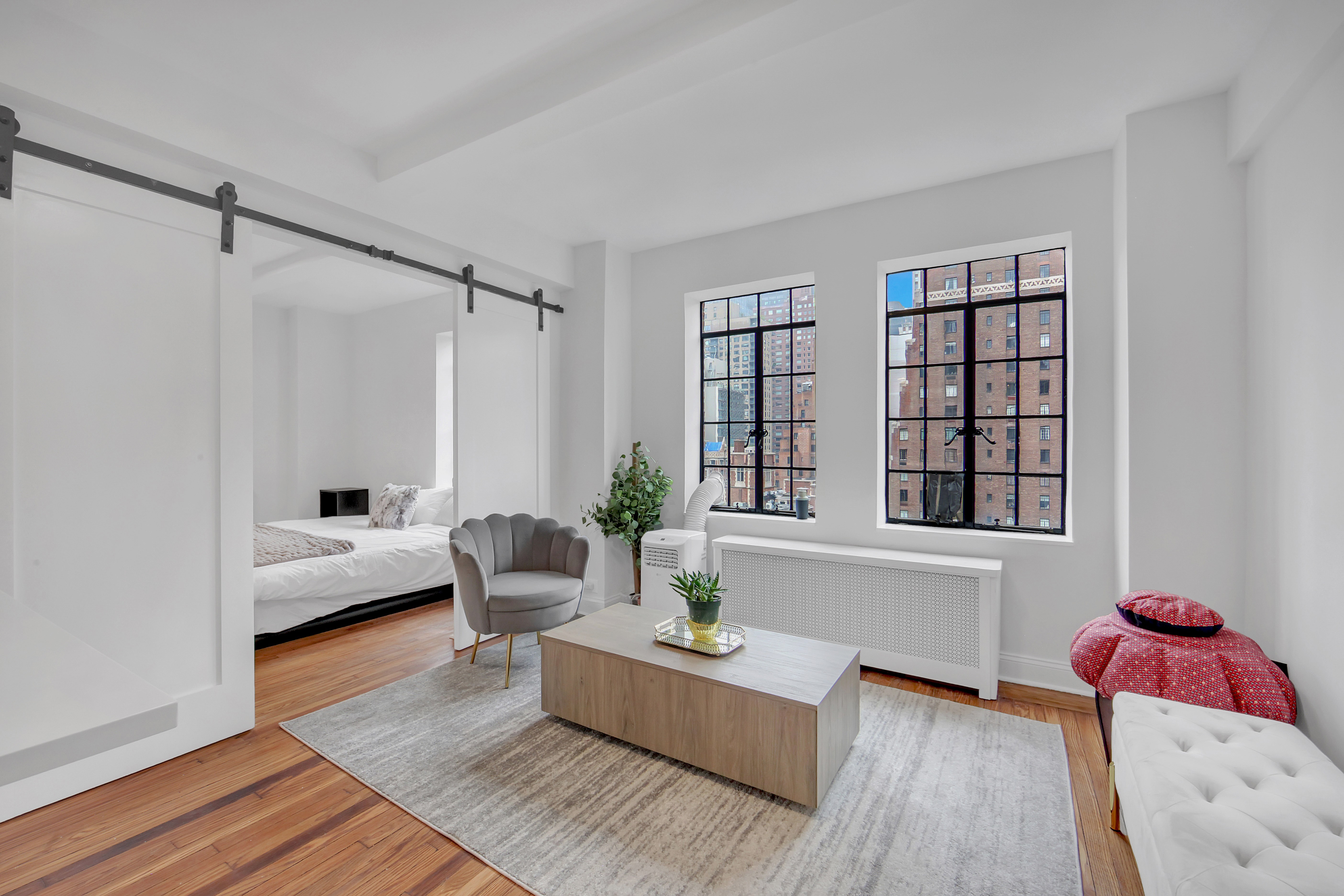 25 Tudor City Place, Unit 1405 Manhattan, NY 10017 - Photo 3 of 21 a living room with furniture and window