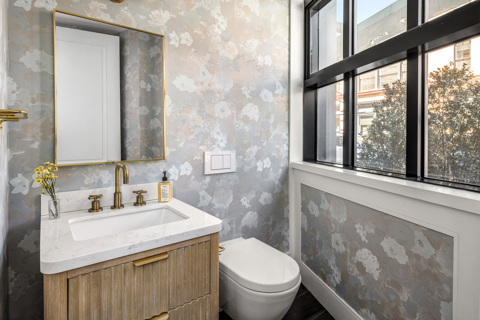 137 Franklin Street, Unit 1 Manhattan, NY 10013 - Photo 21 of 25 a bathroom with a sink toilet and mirror