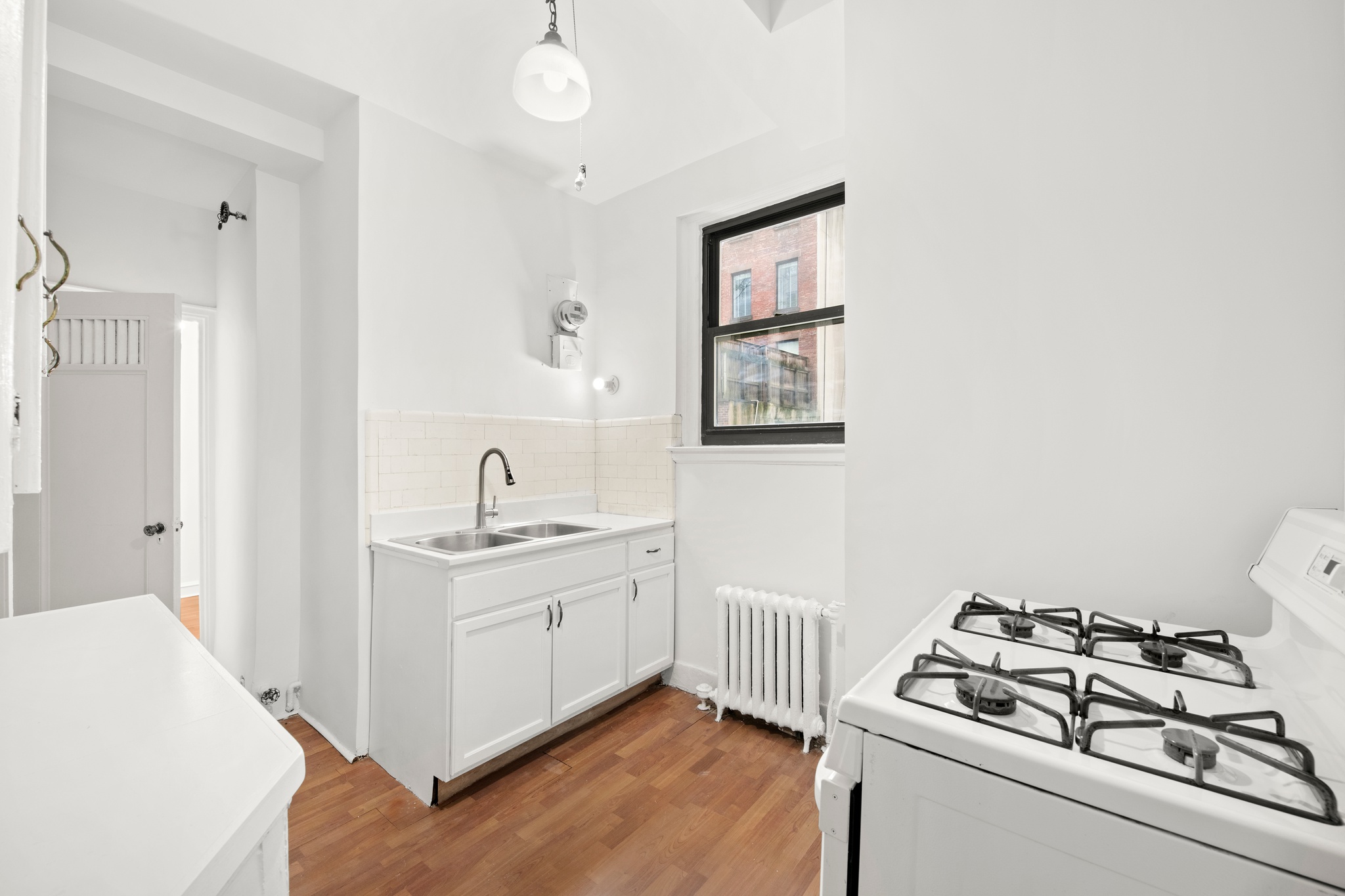 55 East 72nd Street, Unit 2NORTH Manhattan, NY 10021 - Photo 8 of 18 a kitchen with stainless steel appliances a white stove top oven and sink