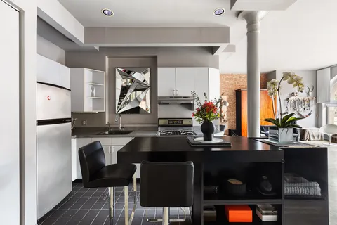 a kitchen with a sink cabinets and window