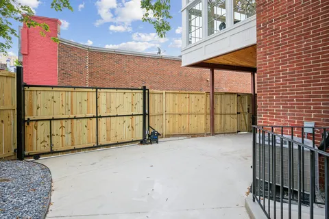 a view of a house with a wooden fence