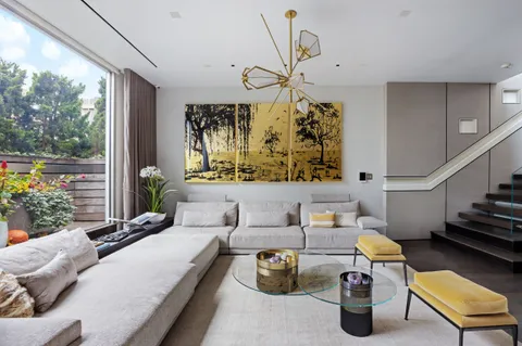 a bedroom with furniture and a large window