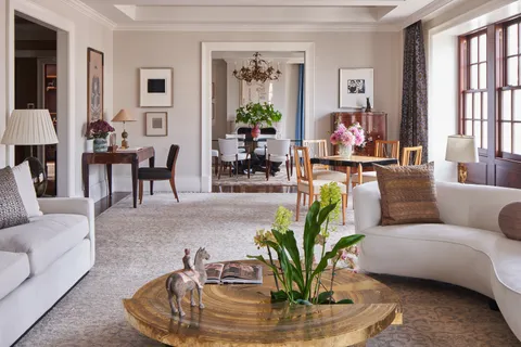 a living room with furniture flowerpot and a window