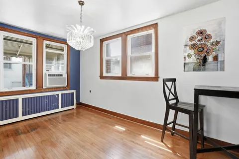 a view of a livingroom with furniture window and wooden floor