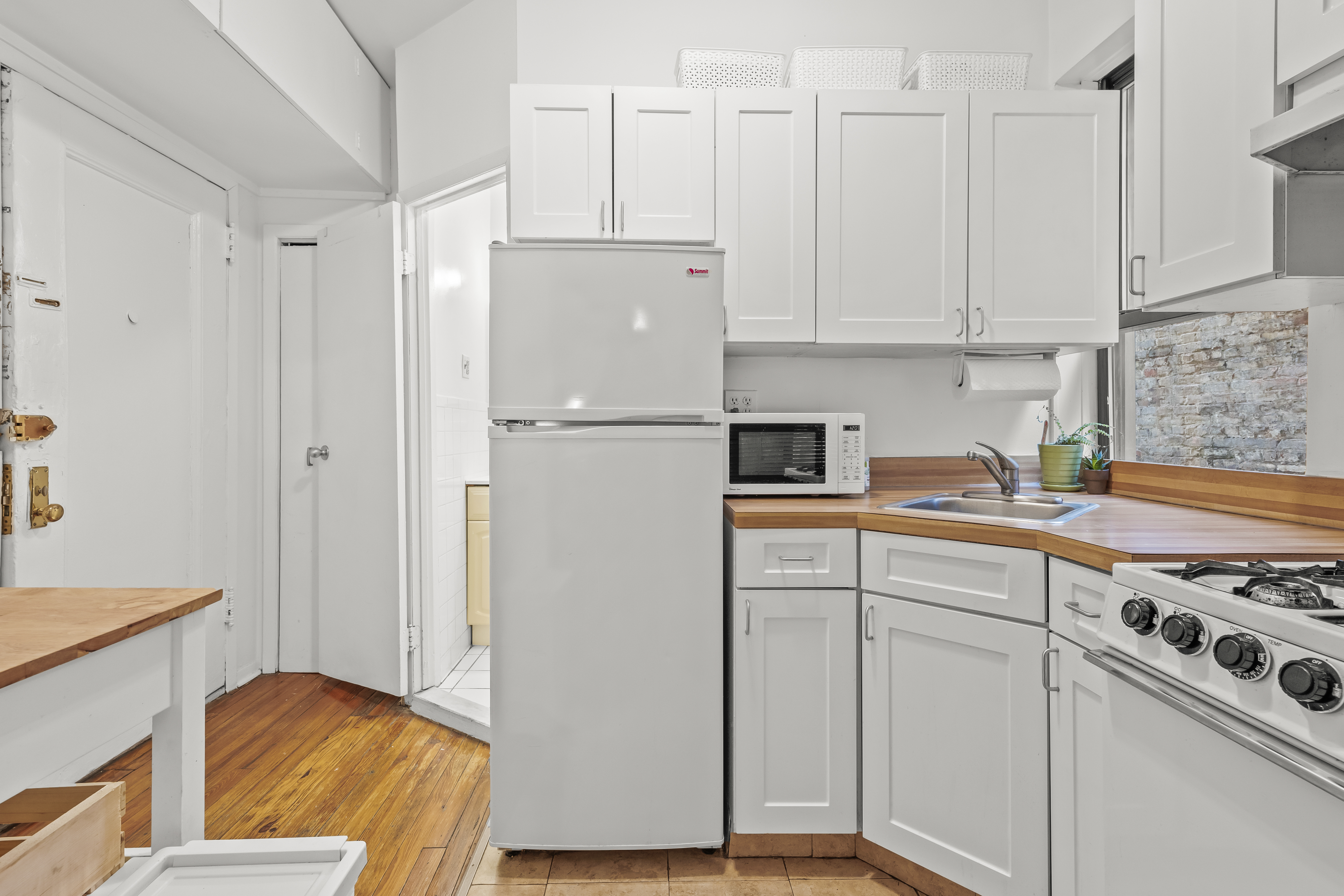204 West 10th Street, Unit 7A Manhattan, NY 10014 - Photo 6 of 17 a kitchen with cabinets and stainless steel appliances