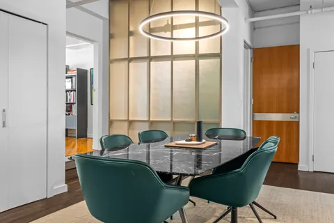 a dining room with furniture and wooden floor