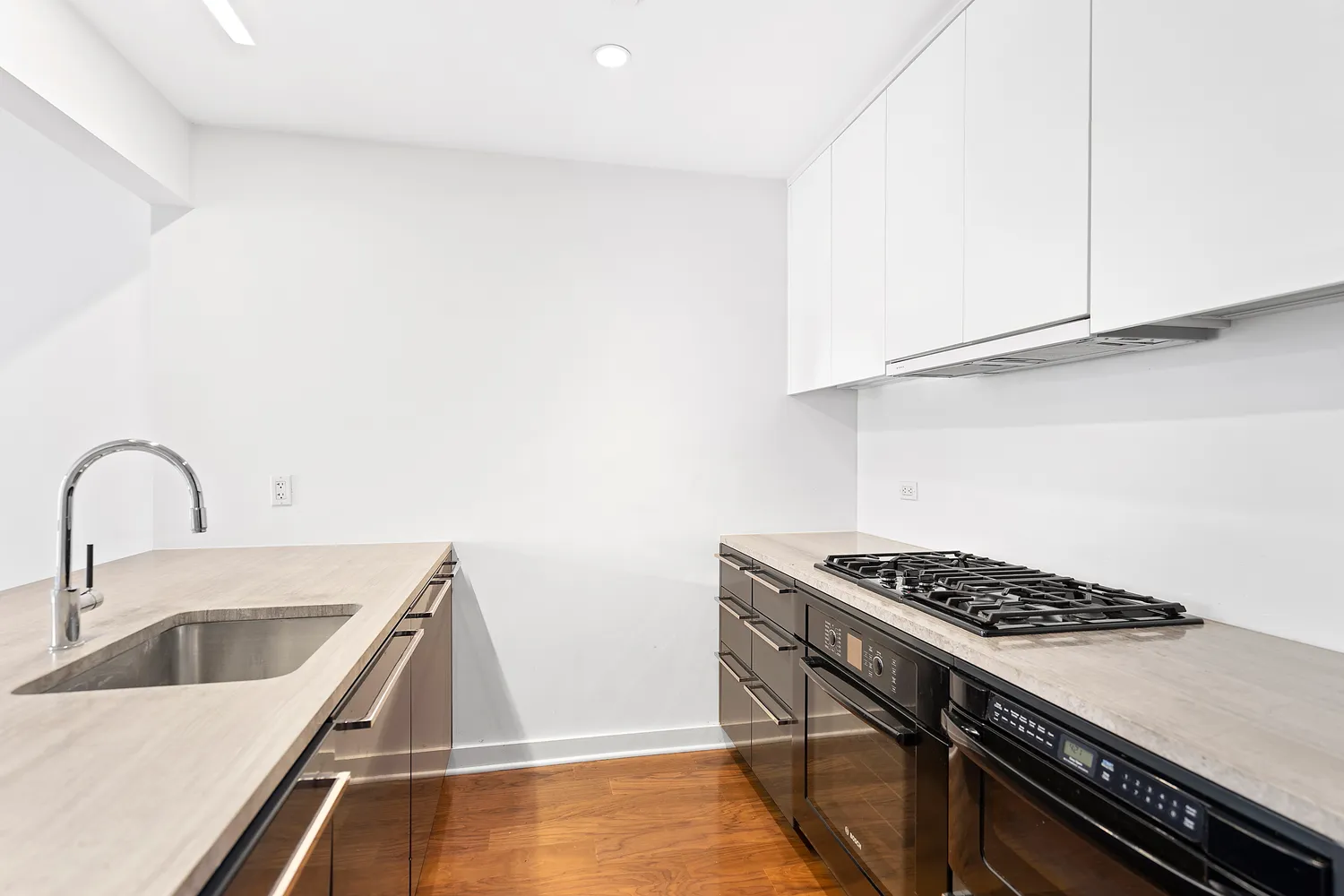 a kitchen that has a sink and a stove