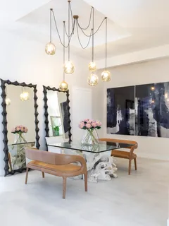 a living room with furniture a chandelier and pool table