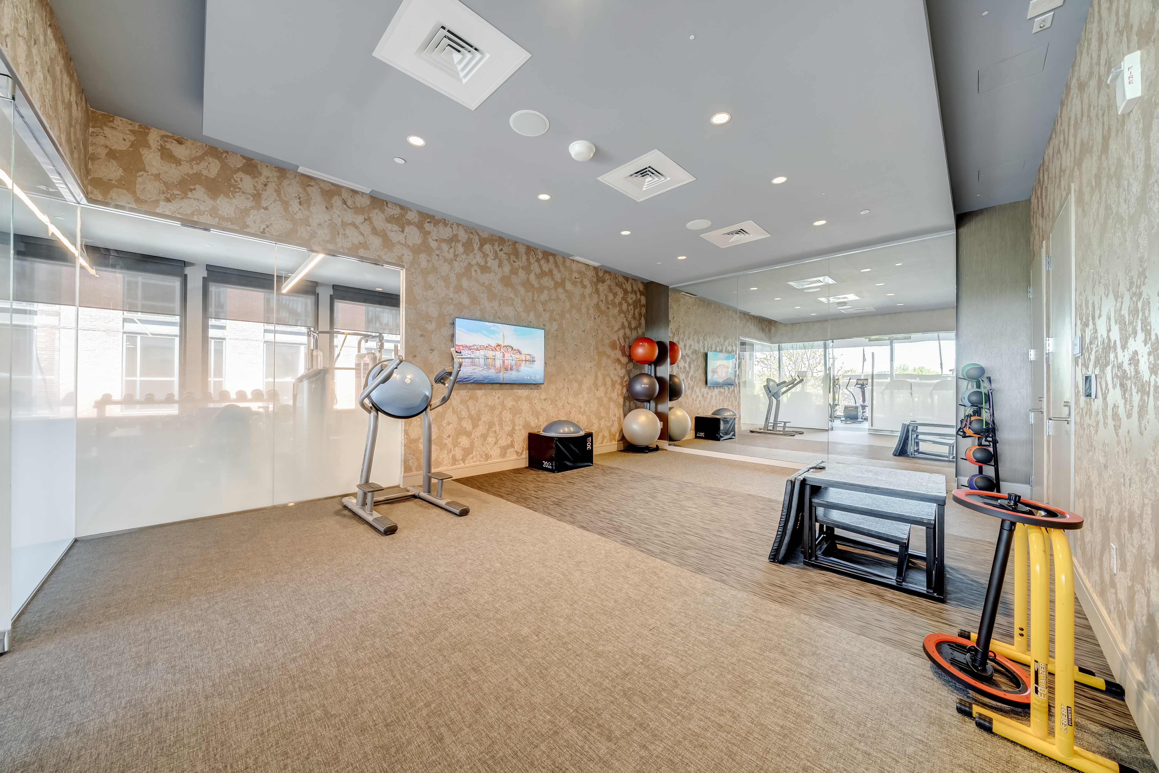45 Sutton Square Southwest, Unit PH10 Washington, DC 20024 - Photo 43 of 44 a living room with furniture gym equipment and a large window