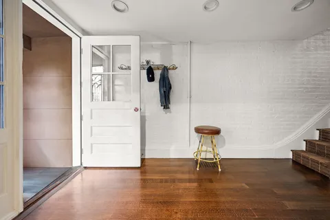 a view of a room with wooden floor and a cabinet
