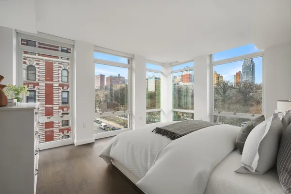 a bedroom with a large bed and a large window