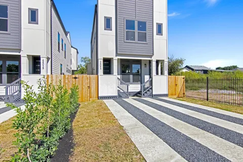 an aerial view of residential houses with outdoor space and street view