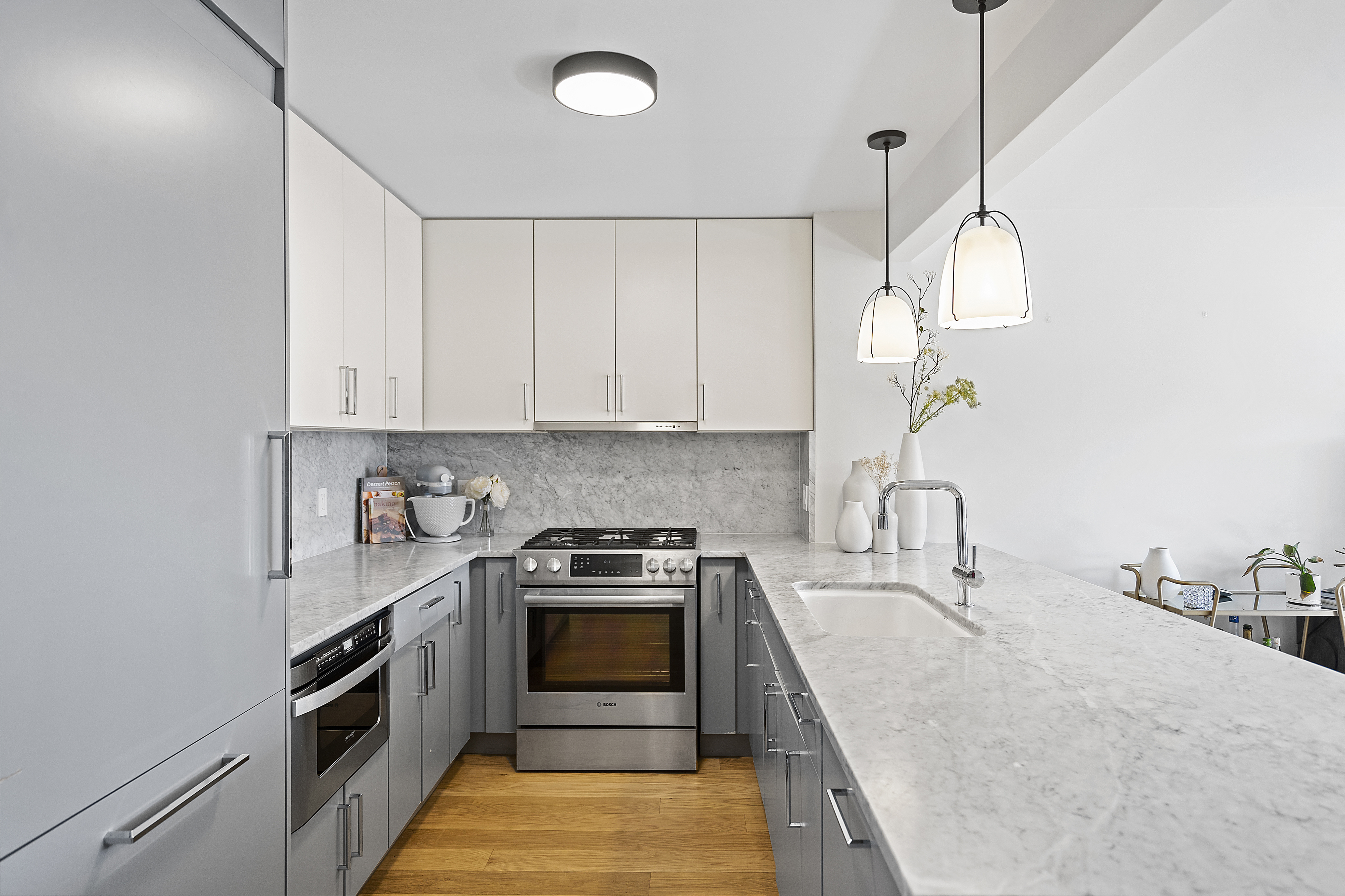 1330 5th Avenue, Unit 6H Manhattan, NY 10026 - Photo 3 of 11 a kitchen with stainless steel appliances granite countertop a sink a stove and a wooden floors