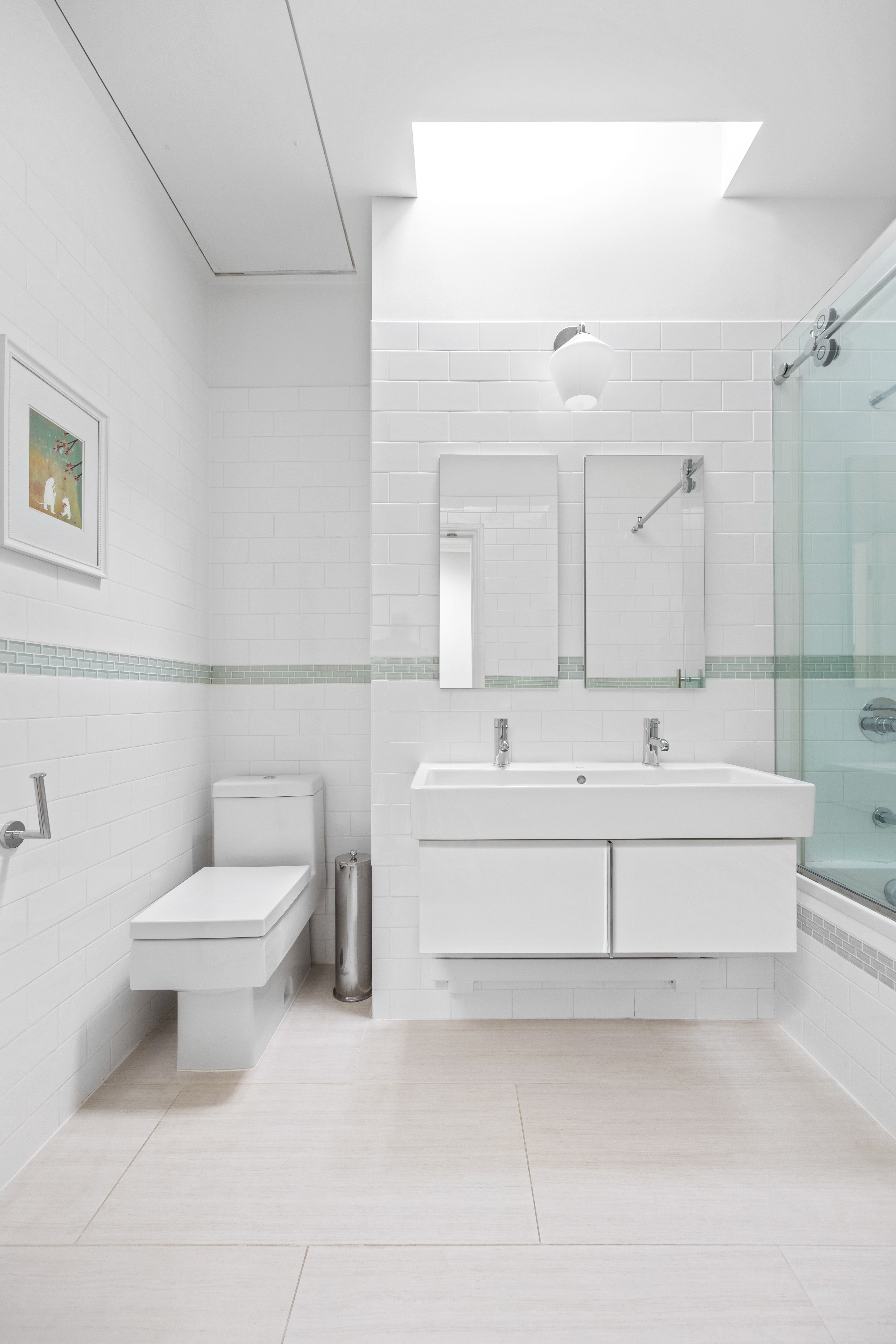 387 Union Street, Unit 2 Brooklyn, NY 11231 - Photo 10 of 12 a bathroom with a white toilet sitting next to a bathroom sink and a mirror