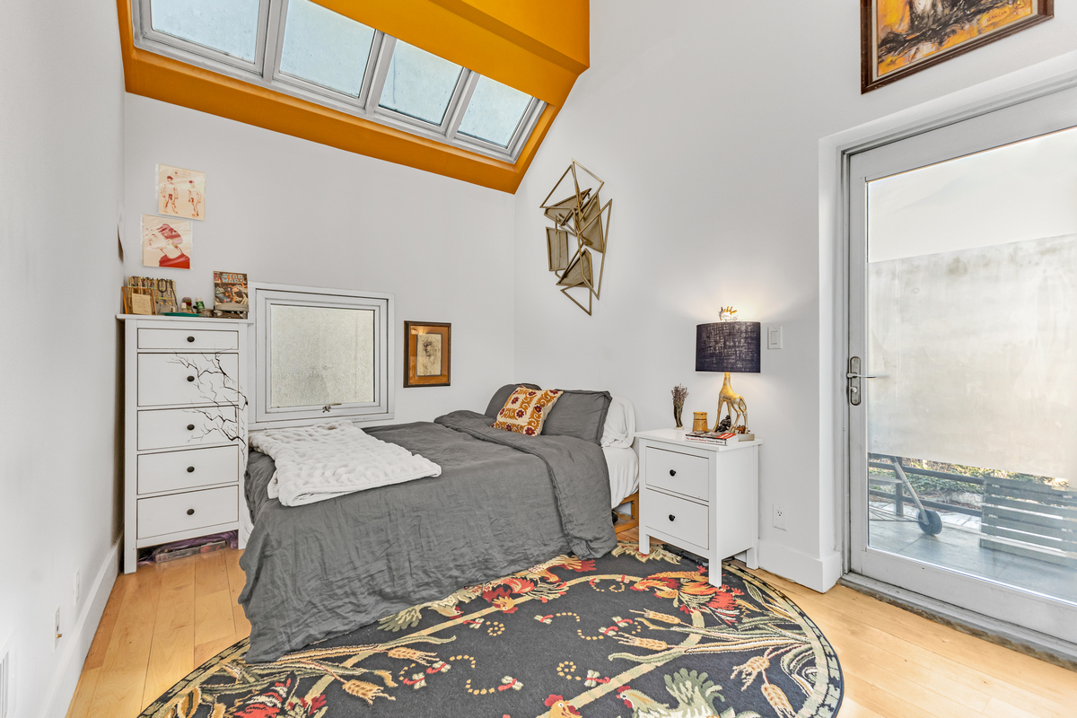 96 Woodpoint Road, Unit 3A Brooklyn, NY 11211 - Photo 9 of 15 a bedroom with a bed and wooden floor