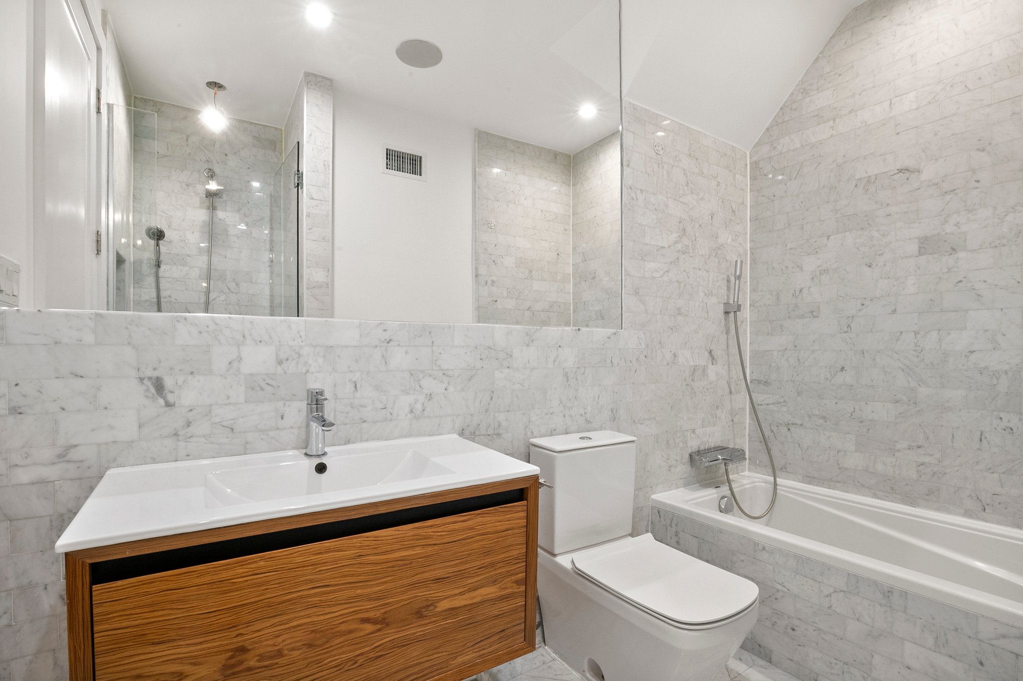 1130 Decatur Street Brooklyn, NY 11207 - Photo 9 of 24 a bathroom with a sink a toilet and shower