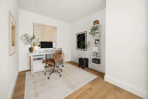 a workspace with furniture and a flat screen tv