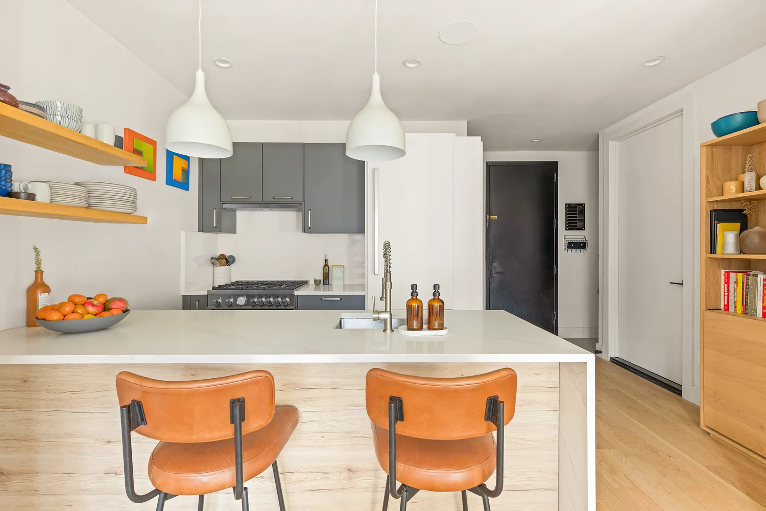 a dining room with stainless steel appliances kitchen island granite countertop a dining table and chairs with wooden floor