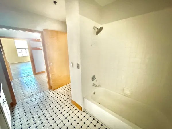 a view of an empty room and a window