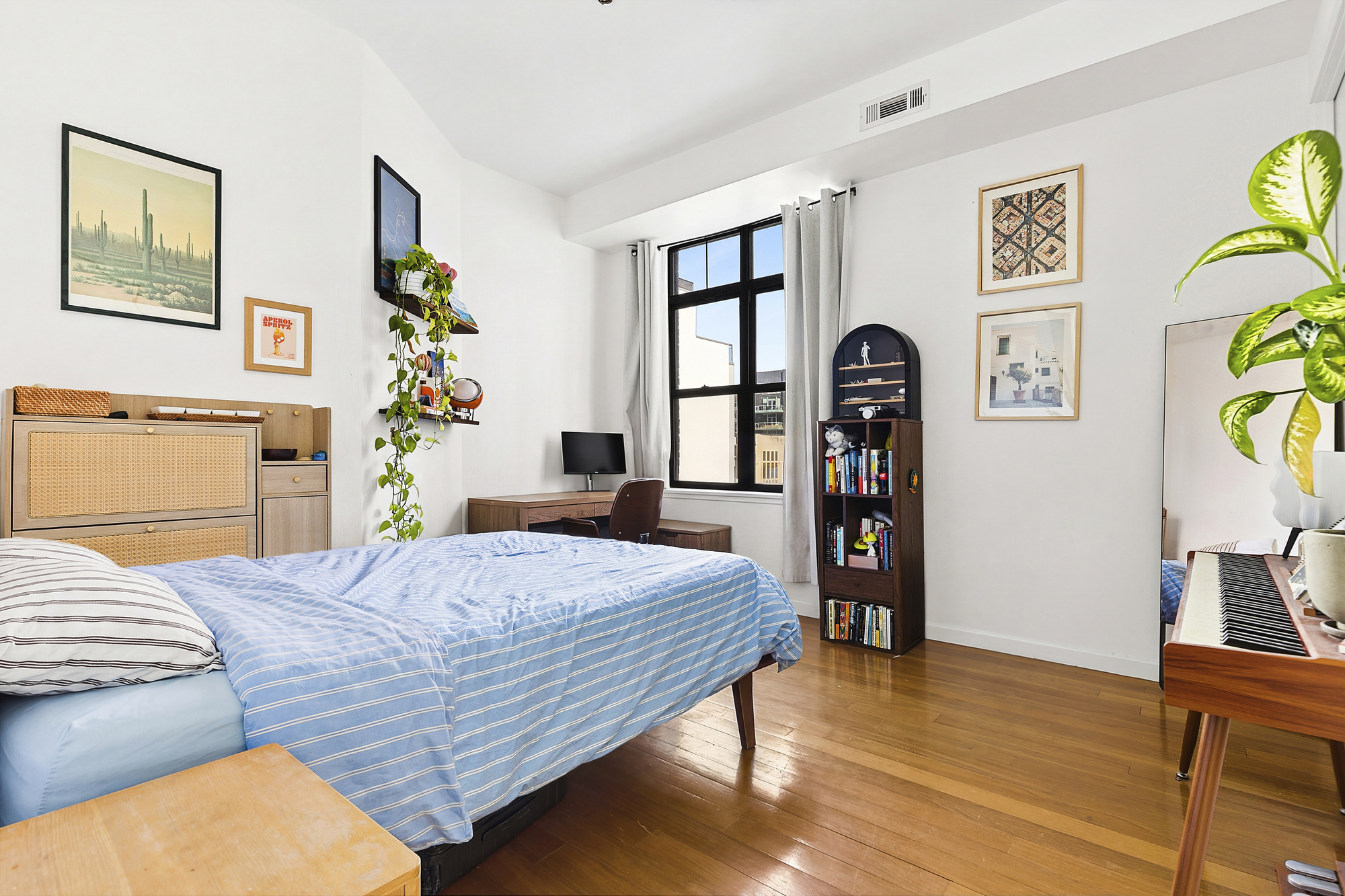 78 Roebling Street, Unit 2B Brooklyn, NY 11211 - Photo 3 of 7 a bedroom with a bed and wooden floor