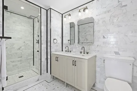 a bathroom with a sink toilet and shower