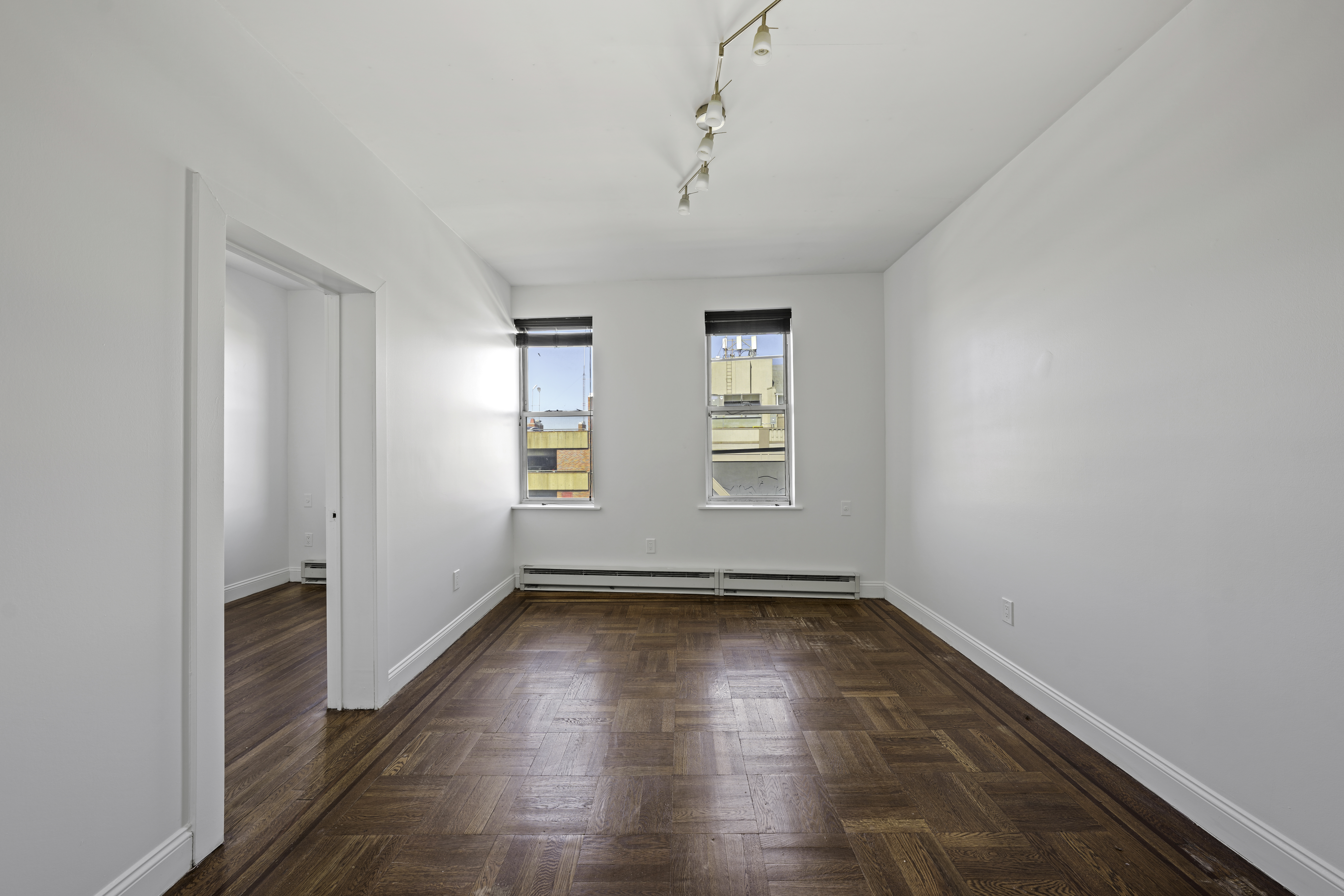 514 86th Street, Unit 4 Brooklyn, NY 11209 - Photo 10 of 19 wooden floor in an empty room with a window