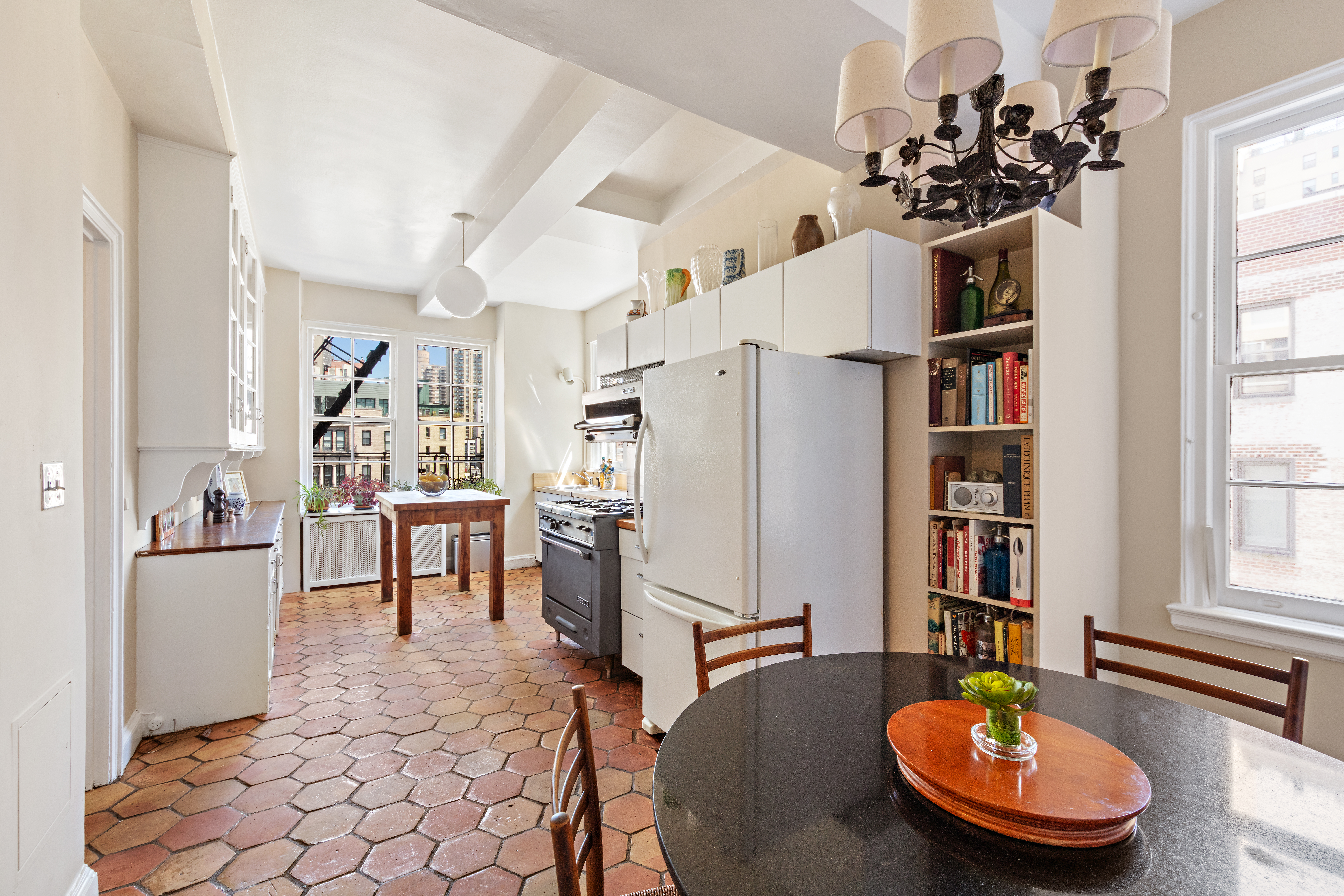 151 East 79th Street Manhattan, NY 10075 - Photo 12 of 15 a living room with dining table and a large window