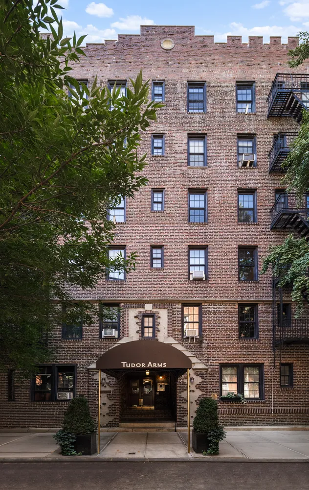 a front view of a building with a garden
