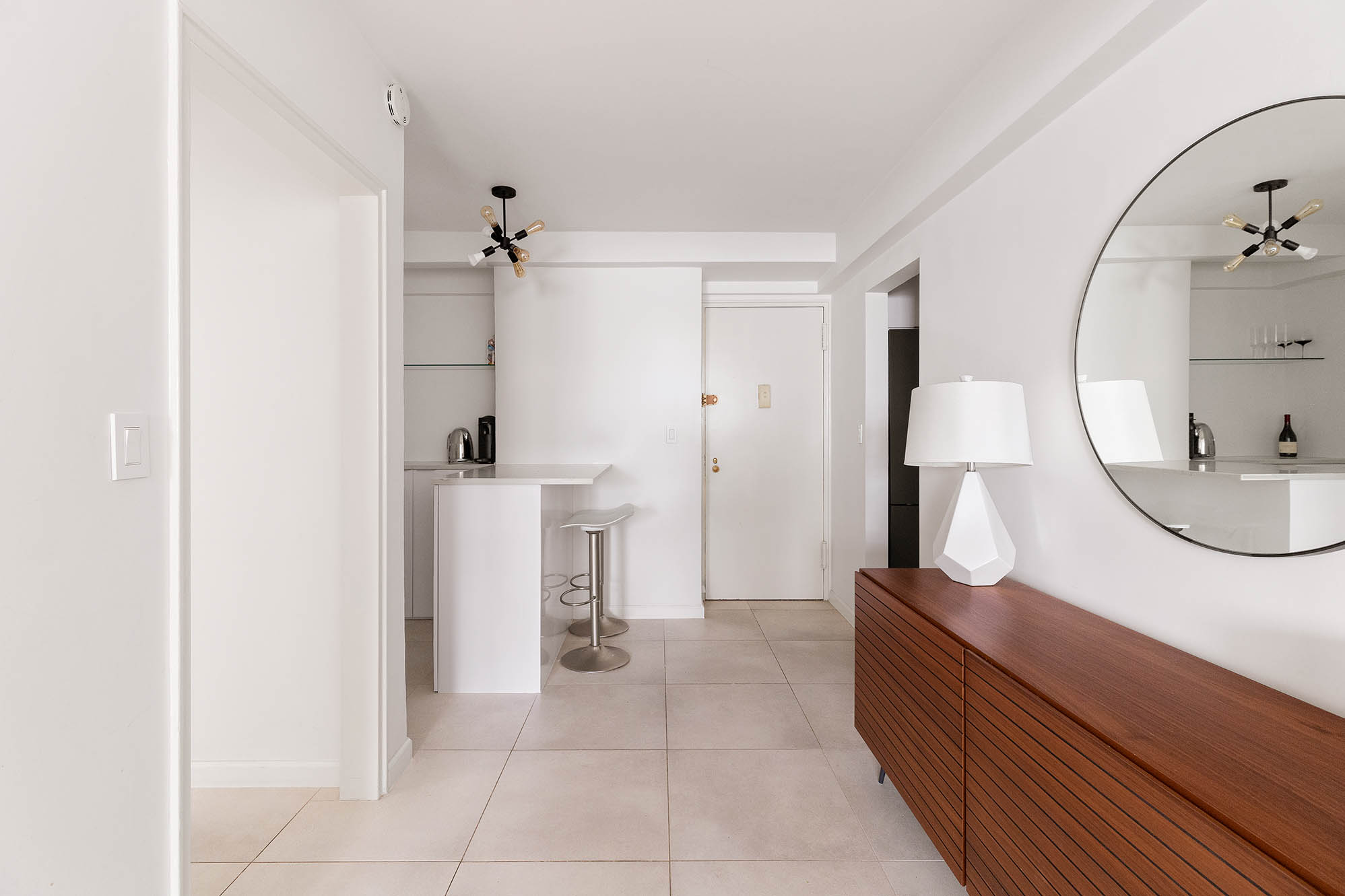135 East 54th Street, Unit 6M Manhattan, NY 10022 - Photo 2 of 10 a bathroom with a sink a toilet and mirror