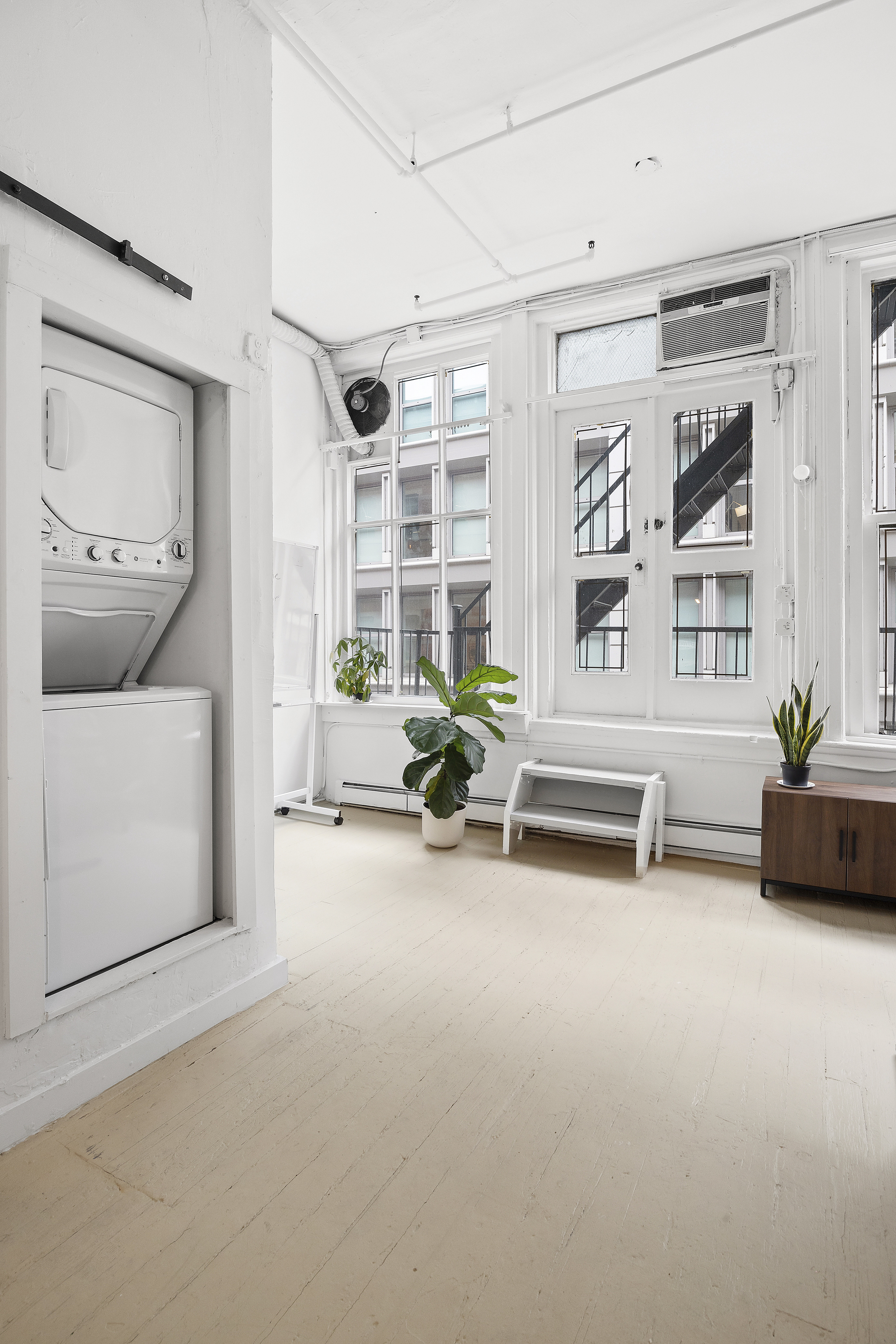 8 Greene Street, Unit 3 Manhattan, NY 10013 - Photo 5 of 7 a living room with furniture and a potted plant