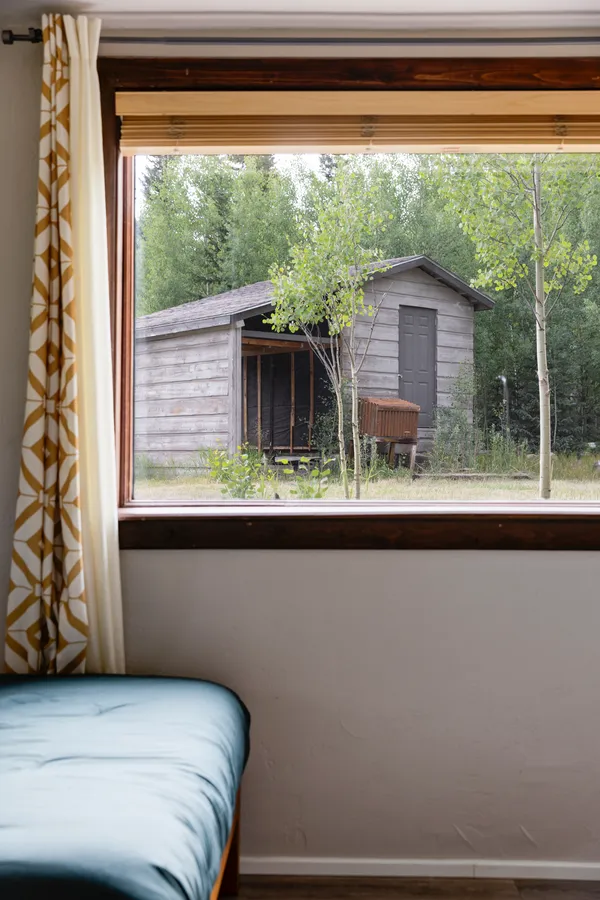 a bedroom with a bed and a large window