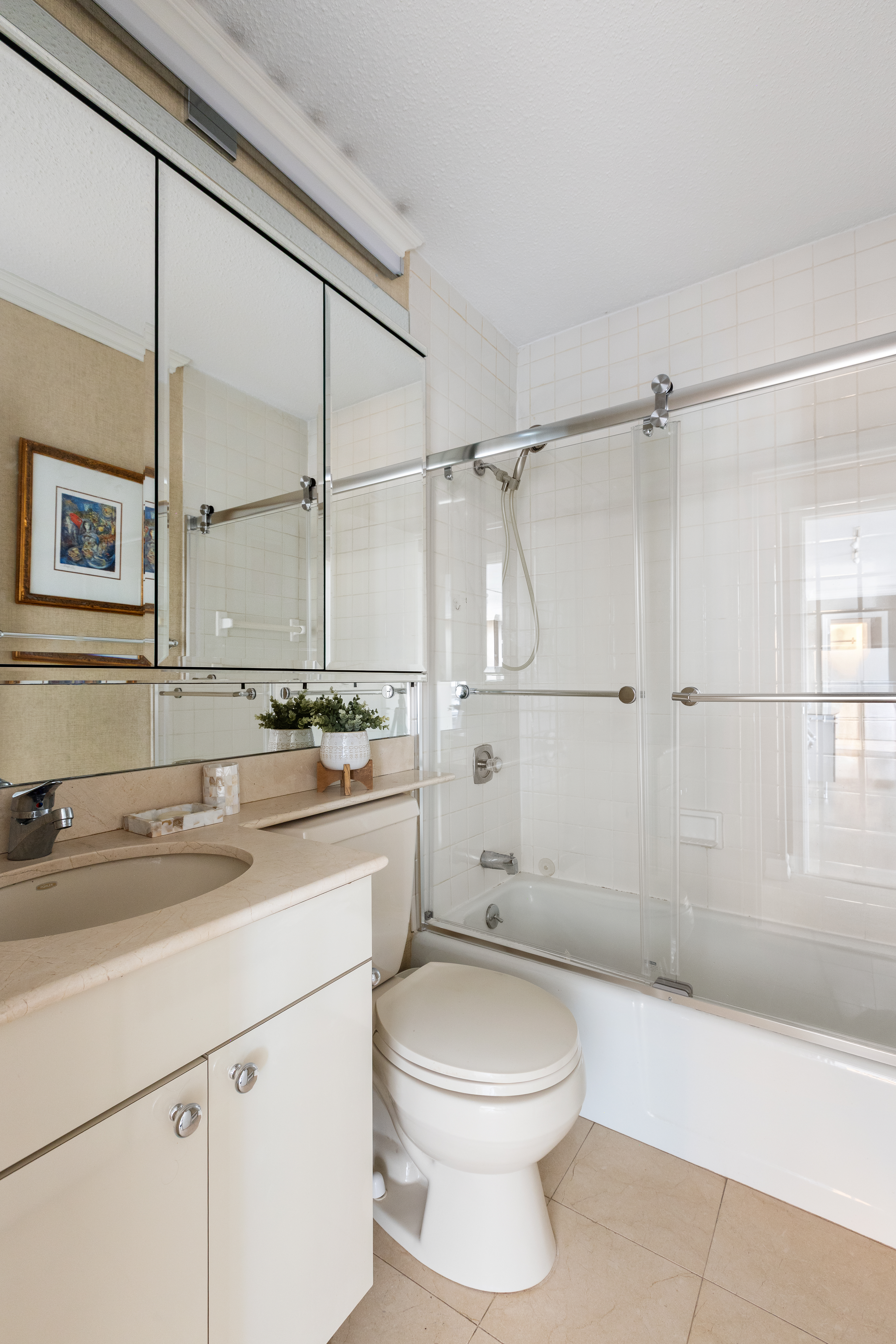 347 West 57th Street, Unit 25AB Manhattan, NY 10019 - Photo 15 of 21 a bathroom with a sink a toilet and shower