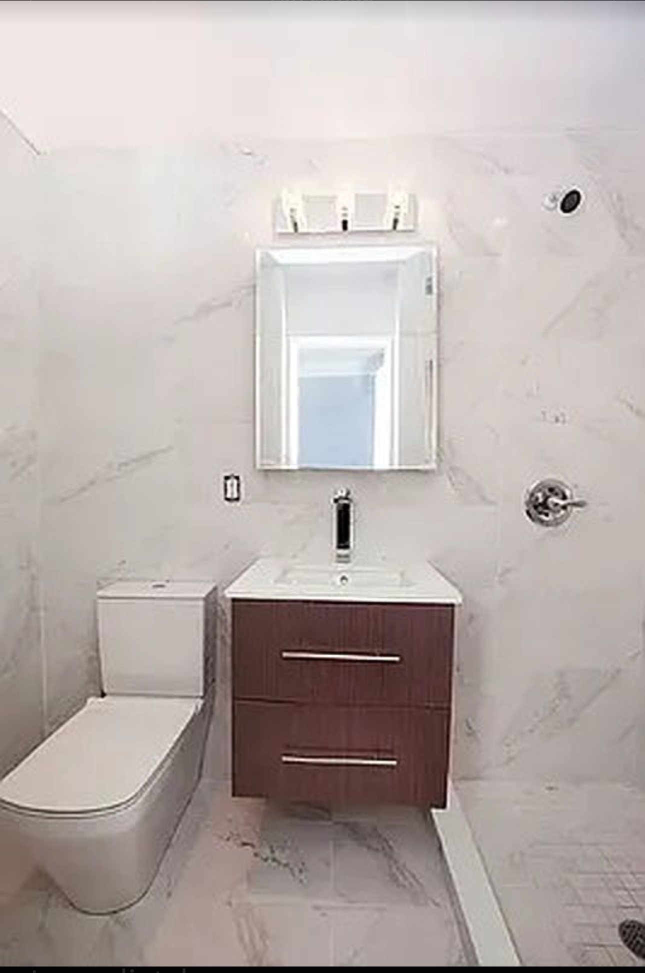 400 East 14th Street, Unit 4C Manhattan, NY 10009 - Photo 2 of 7 a bathroom with a toilet a sink and mirror