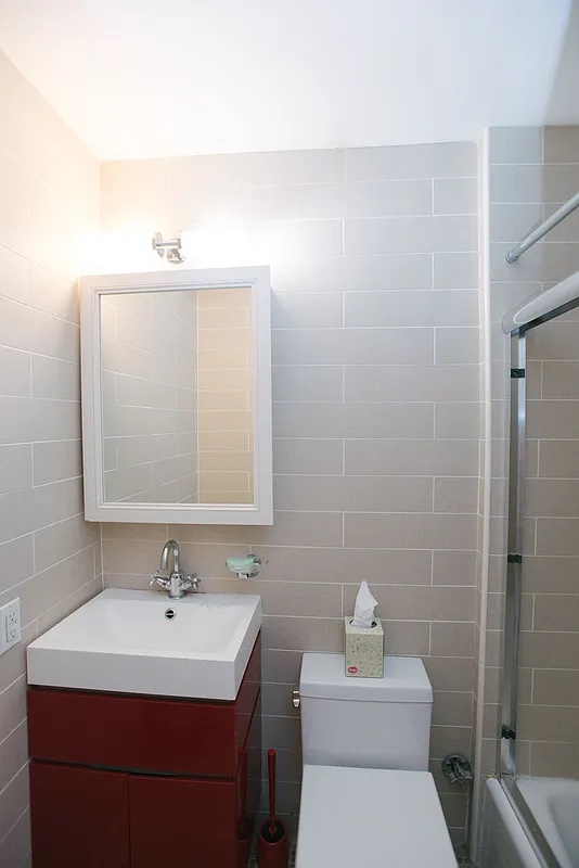 161 West 71st Street, Unit 1A Manhattan, NY 10023 - Photo 5 of 7 a bathroom with a sink toilet and mirror