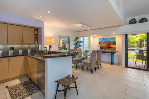 a kitchen with a sink dining table and chairs