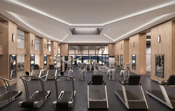 a room with gym equipment and large windows