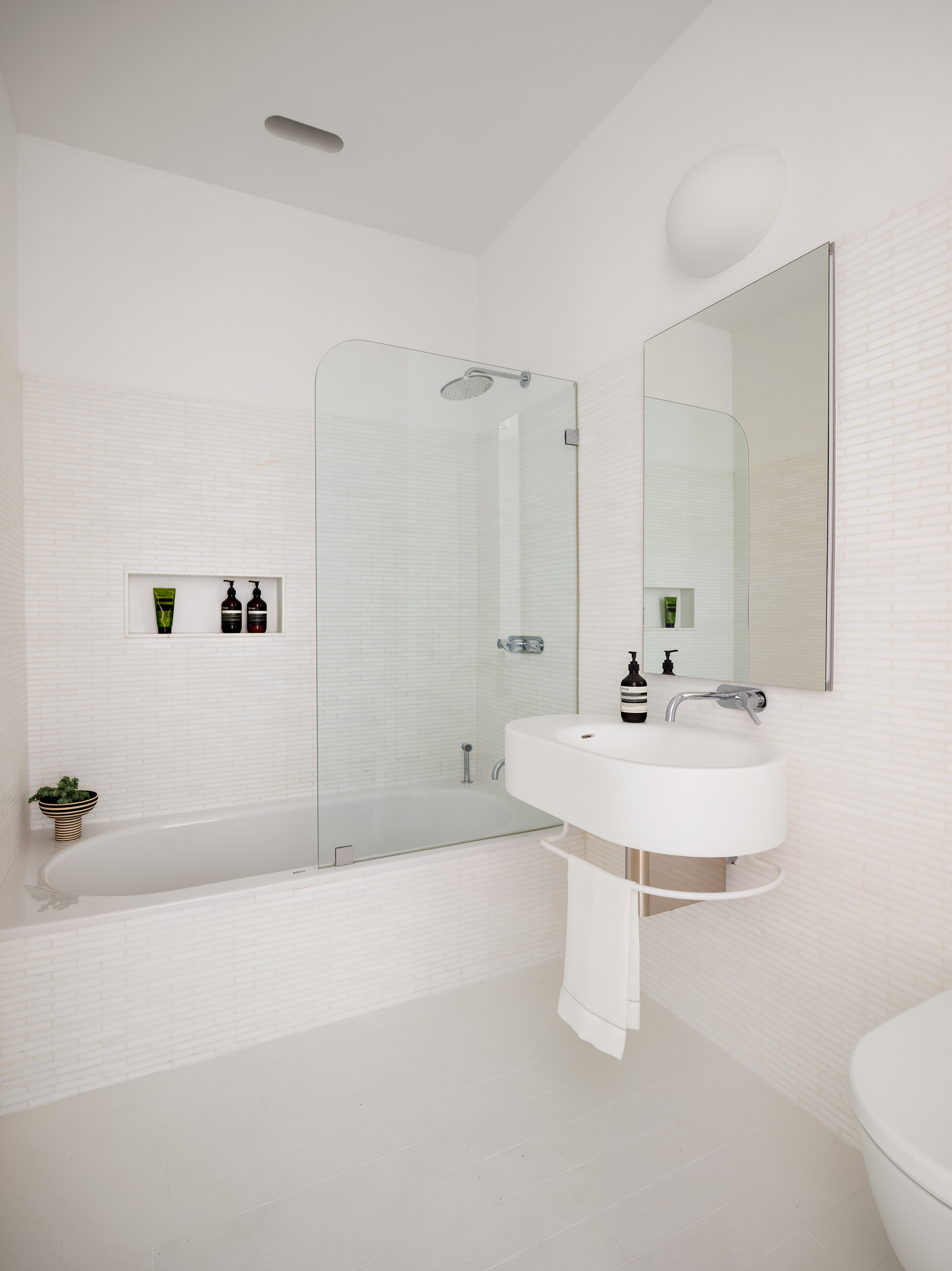 56 Leonard Street, Unit 33AWEST Manhattan, NY 10013 - Photo 9 of 12 a bathroom with a sink a toilet and shower