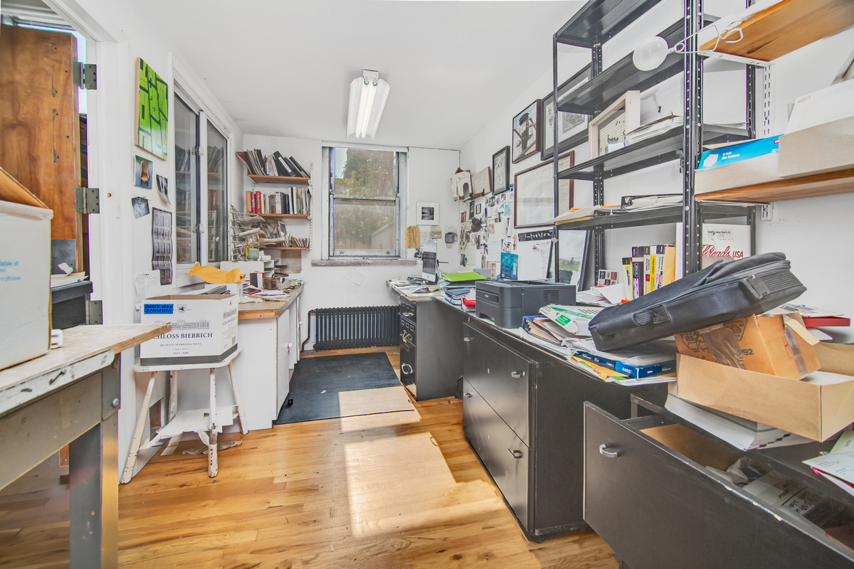 5-38 47th Road Queens, NY 11101 - Photo 5 of 14 a large kitchen with stainless steel appliances kitchen island granite countertop a sink and cabinets