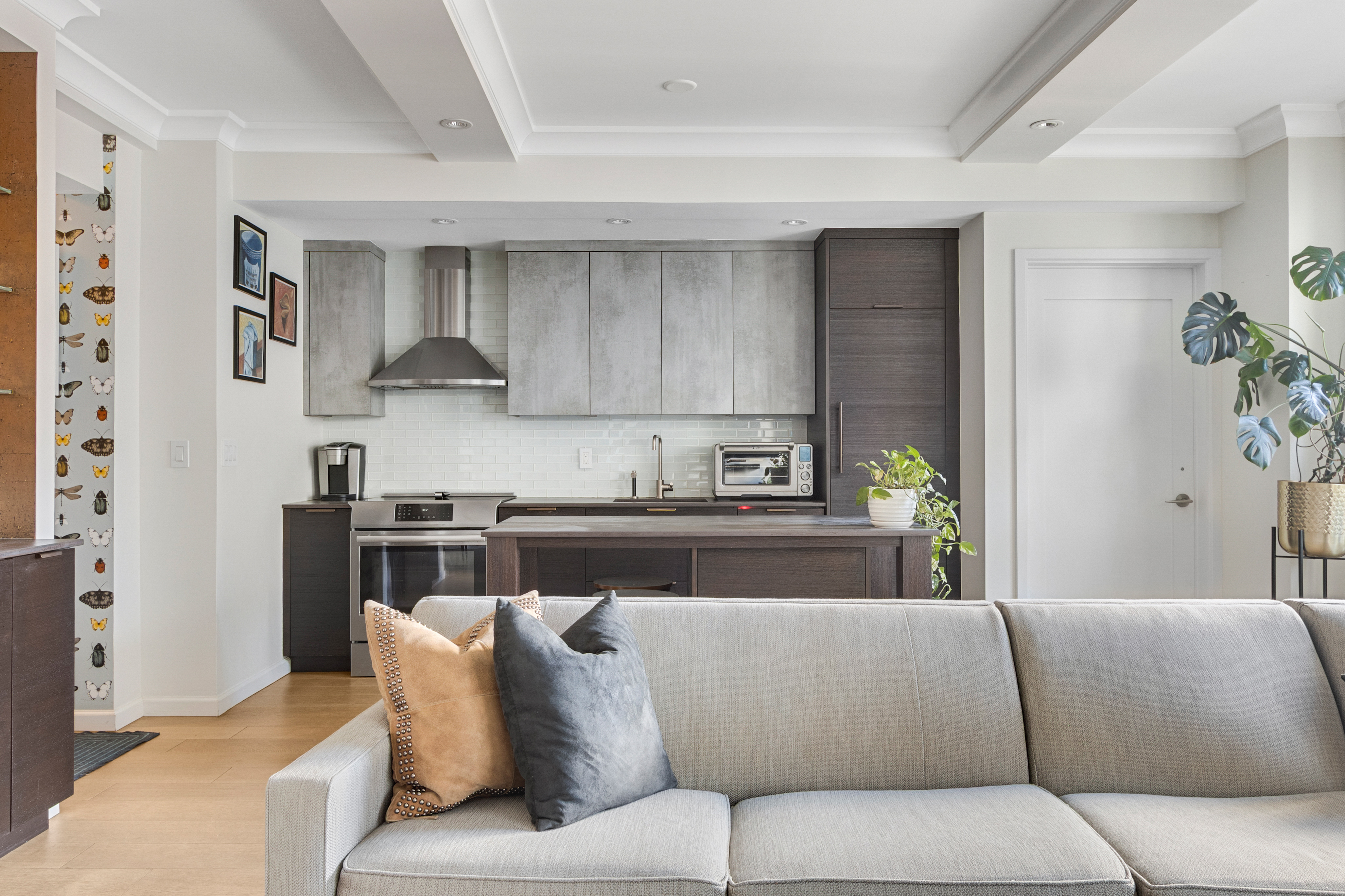225 Central Park West, Unit 1516 Manhattan, NY 10024 - Photo 4 of 16 a living room with stainless steel appliances kitchen island granite countertop furniture and a wooden floor