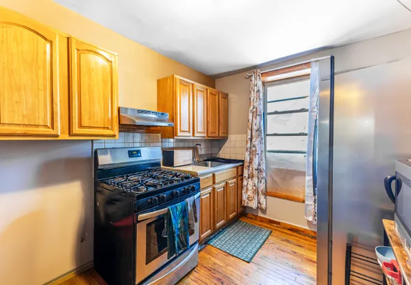 a kitchen with stainless steel appliances granite countertop a stove and a refrigerator