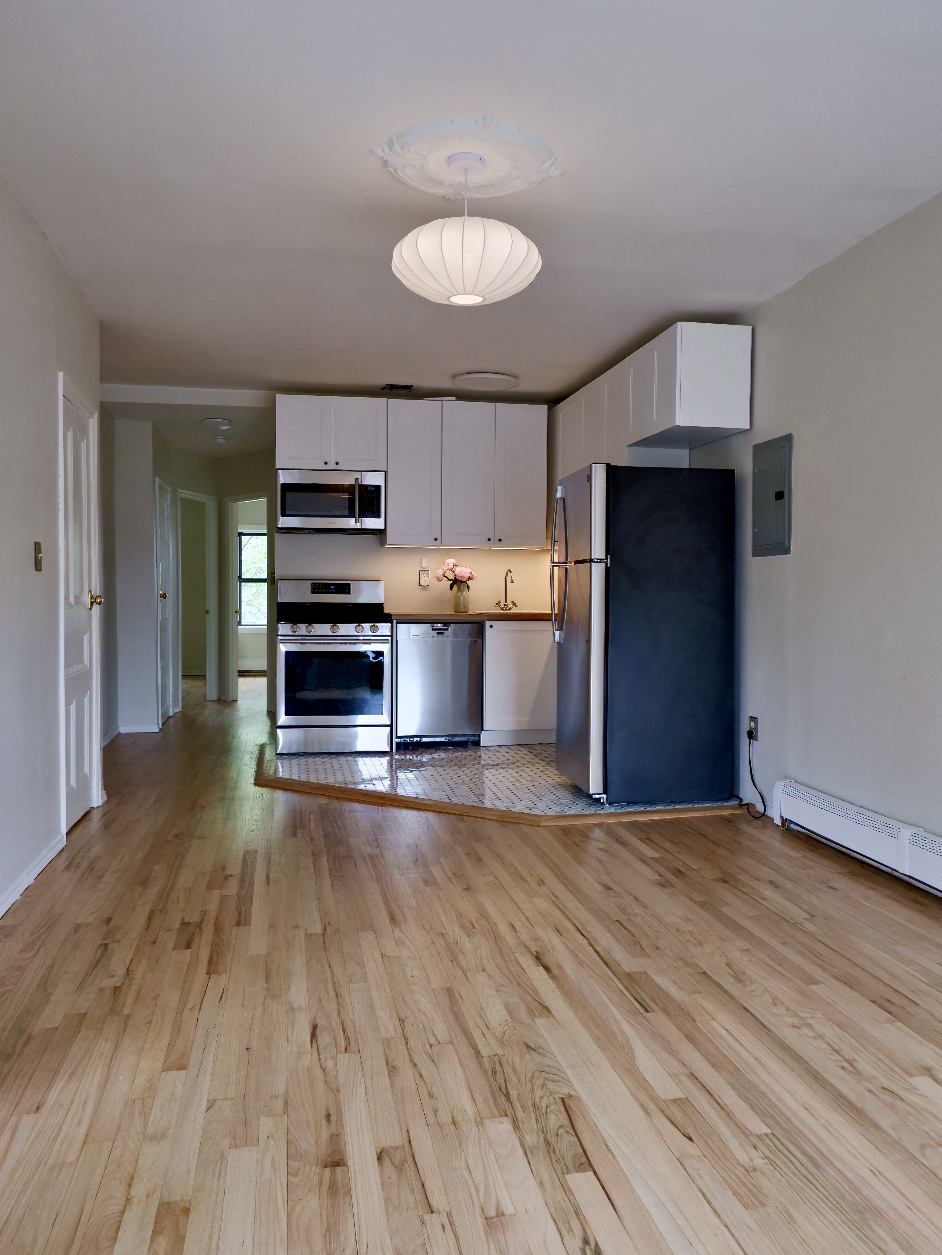 132 Decatur Street, Unit 3 Brooklyn, NY 11216 - Photo 9 of 17 a view of a kitchen with a sink and a stove top oven