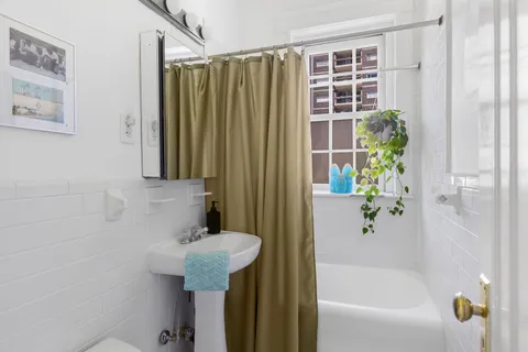 a bathroom with a shower and a sink