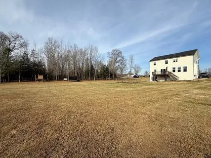 a view of a big room with trees and a building in the background