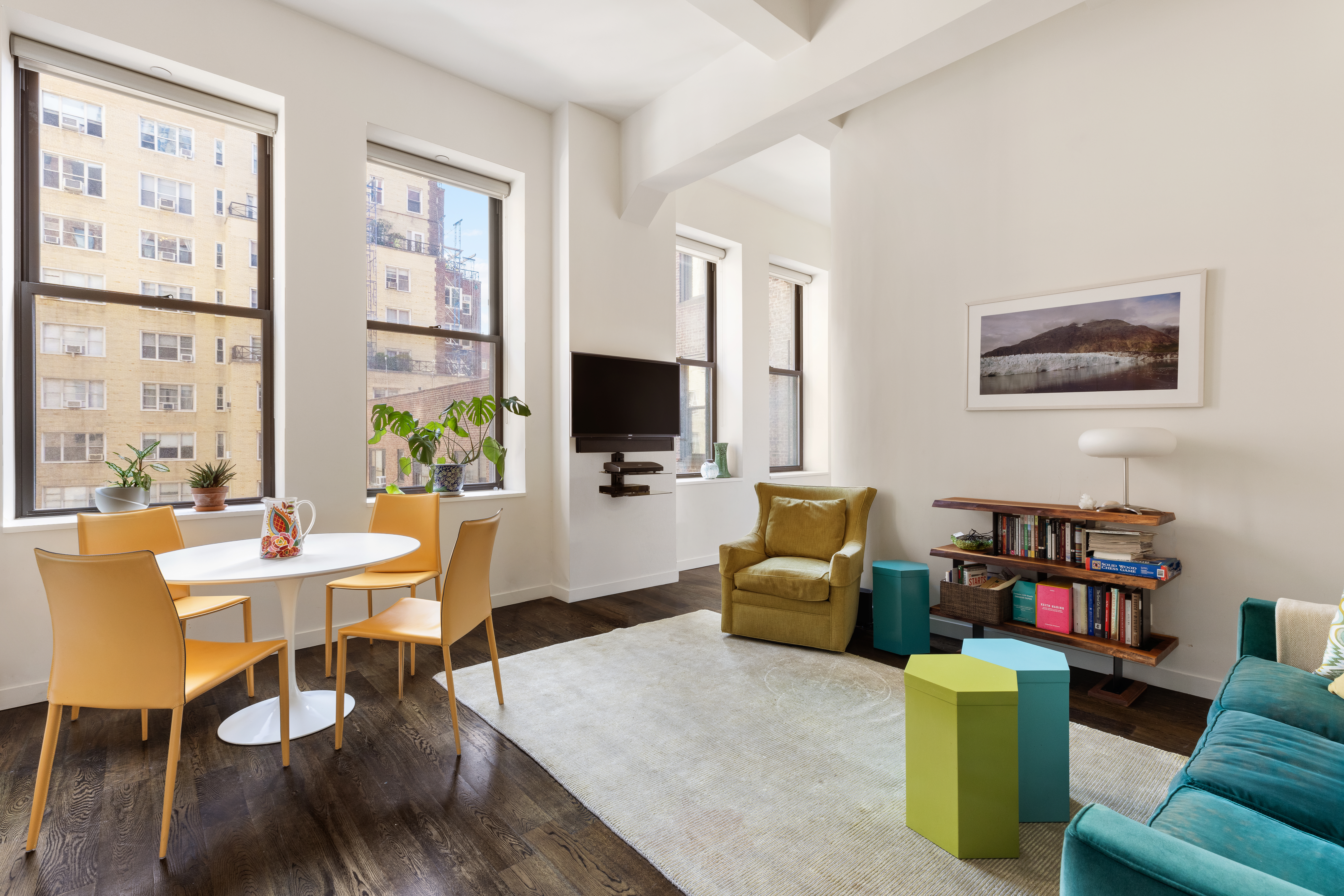 11 East 36th Street, Unit 605 Manhattan, NY 10016 - Photo 2 of 6 a living room with furniture a flat screen tv and a window