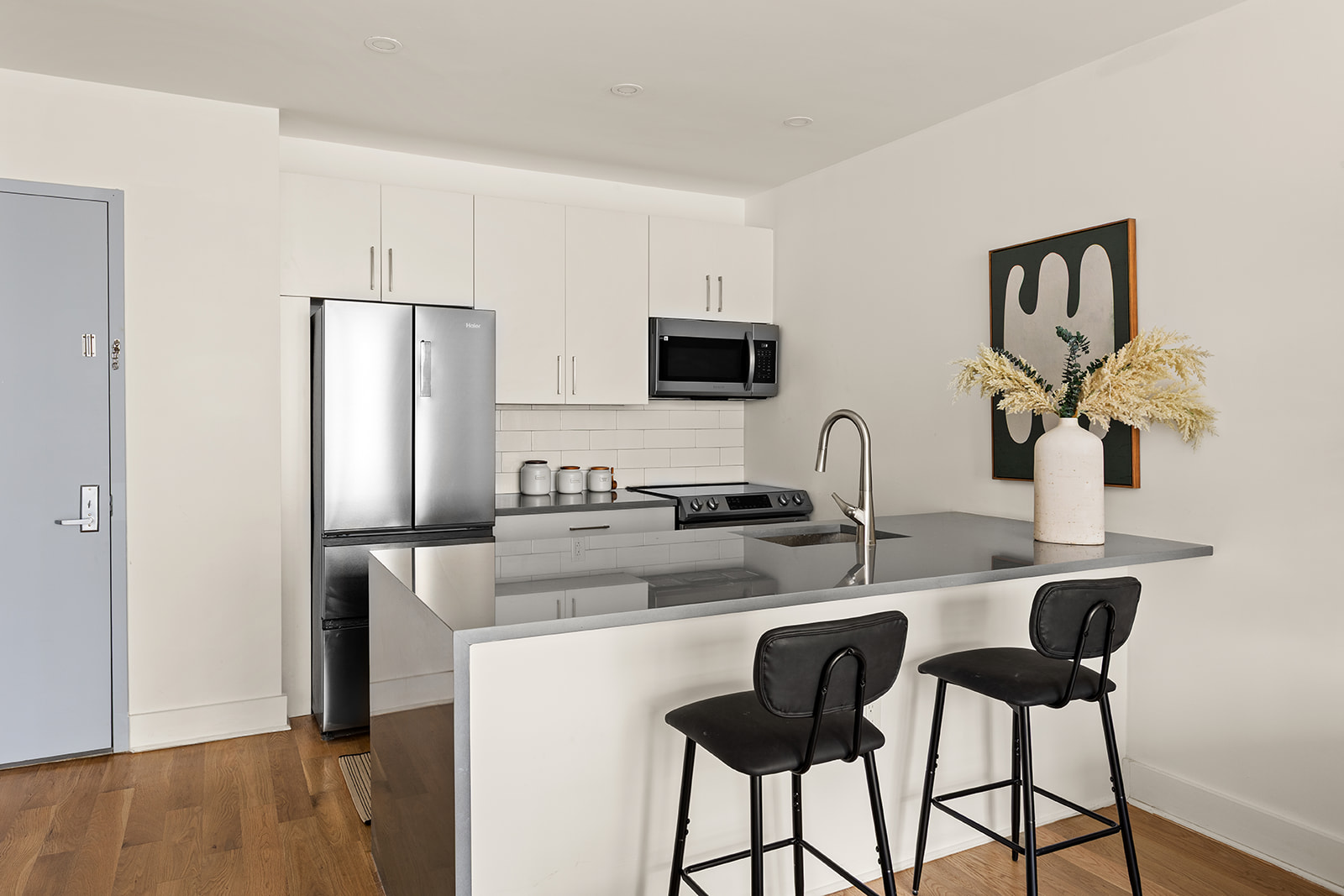 40 Schaefer Street, Unit 2A Brooklyn, NY 11207 - Photo 3 of 9 a kitchen with stainless steel appliances granite countertop a sink and a refrigerator