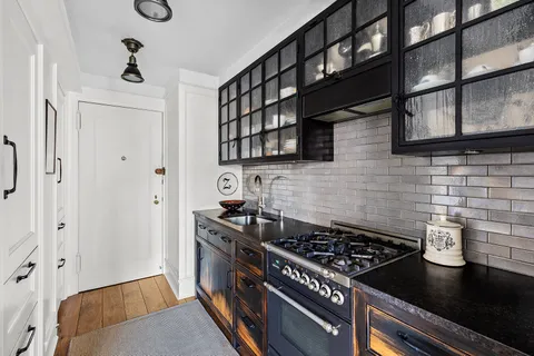 a kitchen with stainless steel appliances granite countertop a stove and a refrigerator