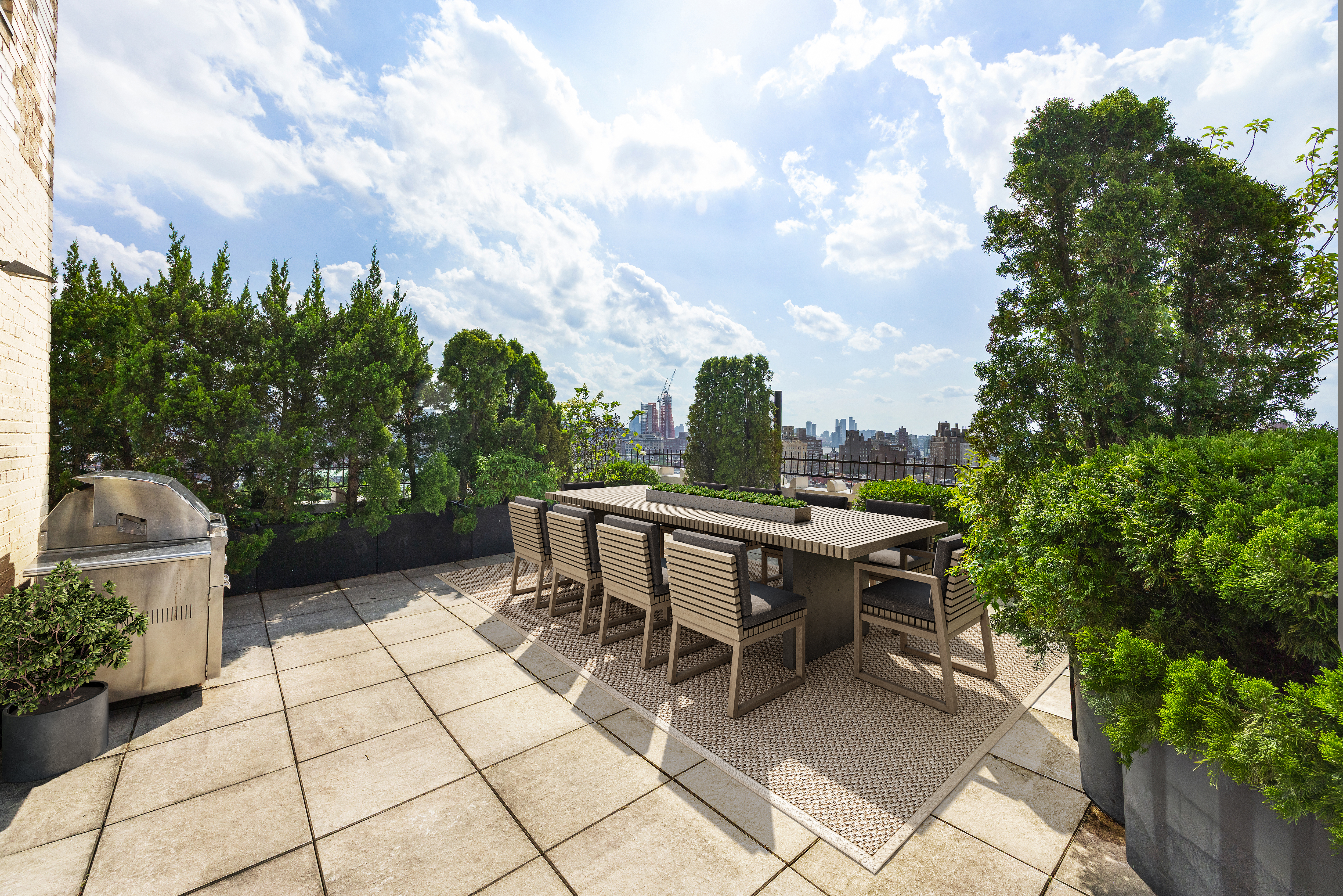 24 5th Avenue, Unit PH1701 Manhattan, NY 10011 - Photo 11 of 24 a view of a tables and chairs in back yard of the house
