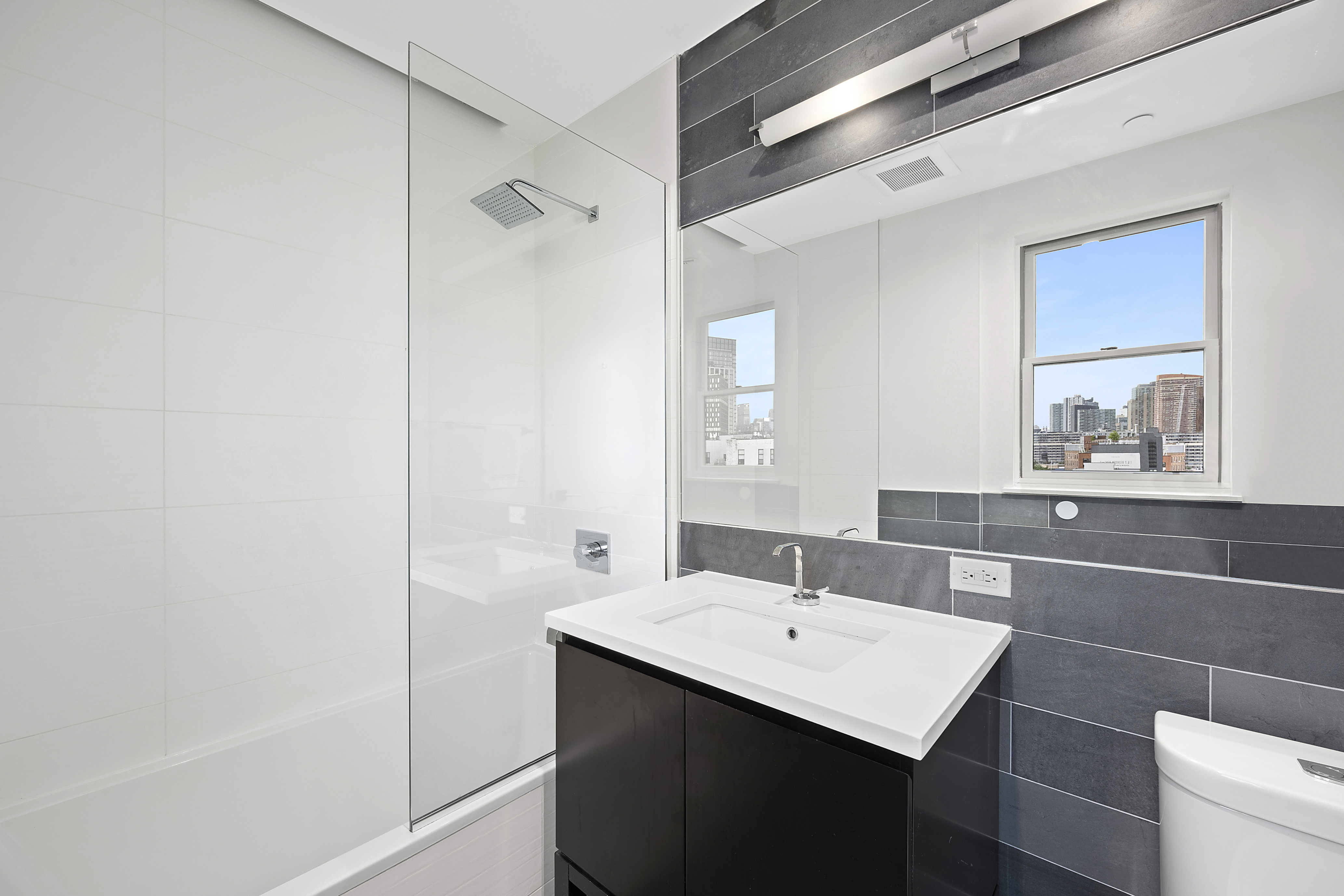 1059 Manhattan Avenue, Unit PHB Brooklyn, NY 11222 - Photo 7 of 8 a bathroom with a sink and a mirror