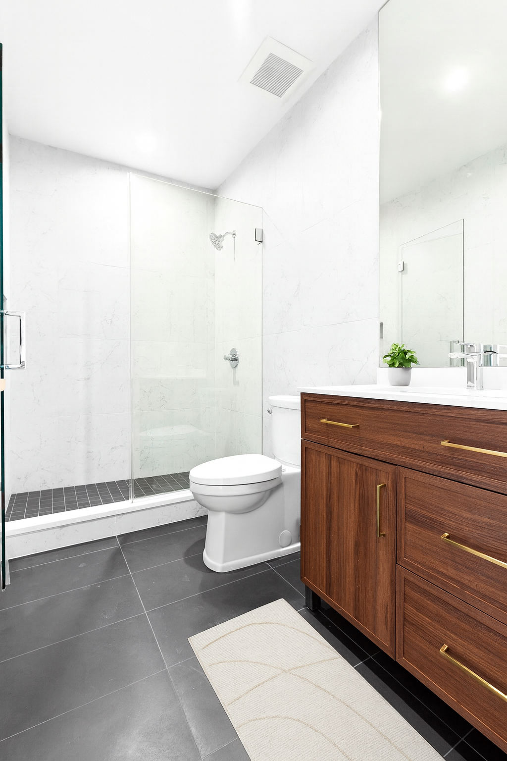 212 Montrose Avenue, Unit 4R Brooklyn, NY 11206 - Photo 7 of 12 a bathroom with a toilet a sink and mirror